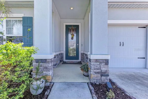 a view of a room with wooden floor mirror and a window