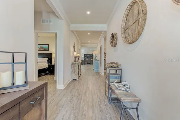 a bedroom with a bed and a window with wooden floor