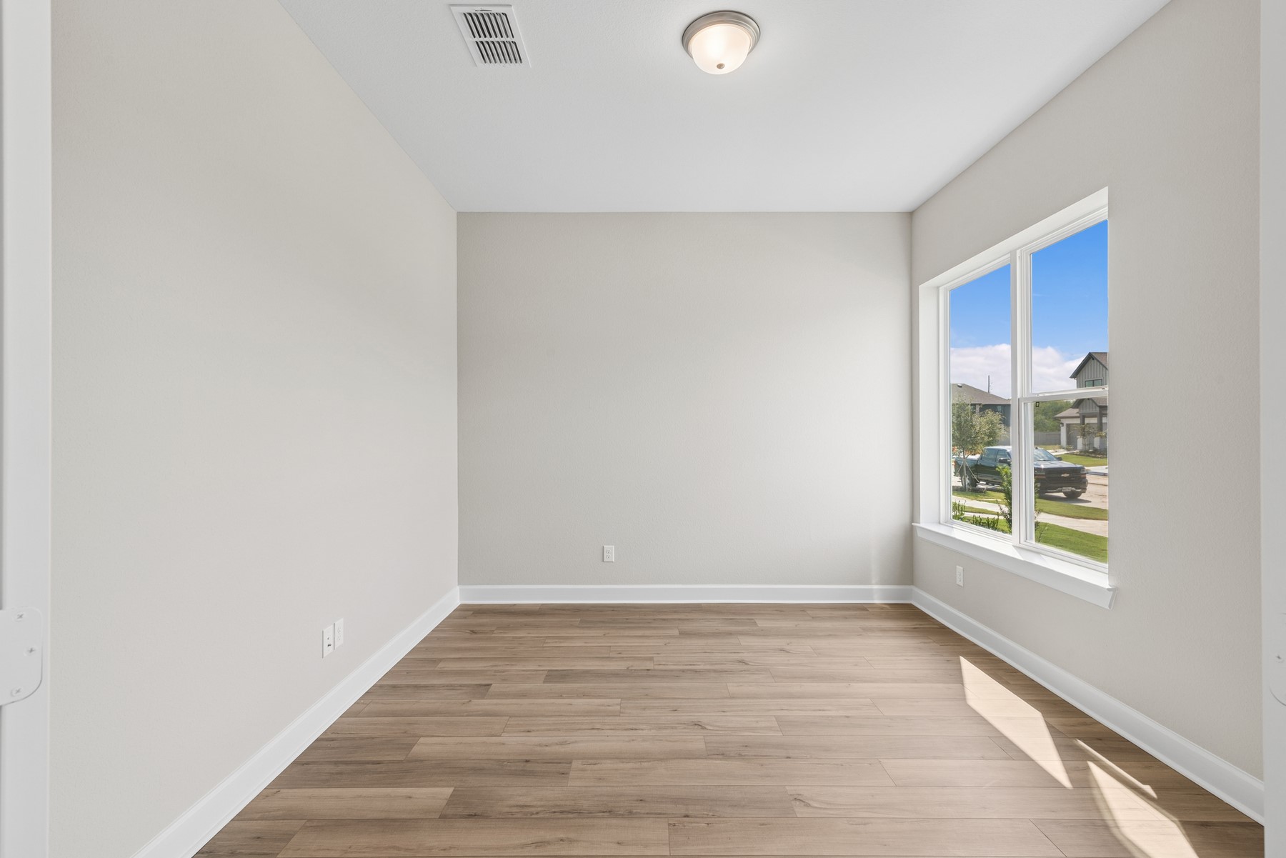 5515 Orangery Lane Manvel, TX 77578 - Photo 13 of 48 a view of an empty room with wooden floor and a window