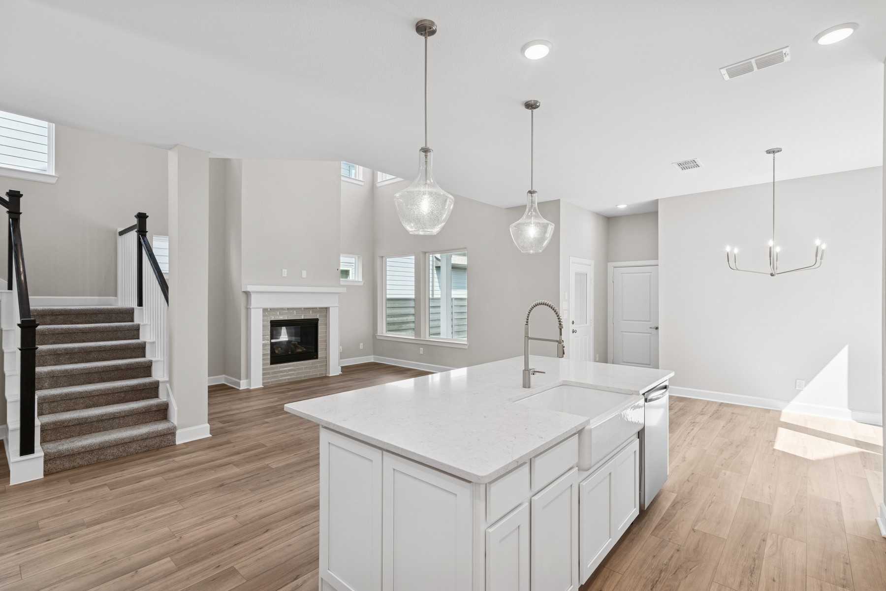 5515 Orangery Lane Manvel, TX 77578 - Photo 23 of 48 a large white kitchen with a sink a fireplace and wooden floor