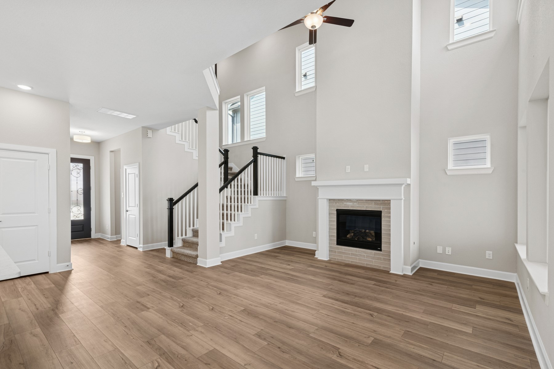 5515 Orangery Lane Manvel, TX 77578 - Photo 26 of 48 a view of a livingroom with wooden floor a fireplace and entryway