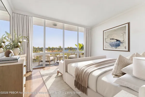 a spacious bedroom with a large bed and a chandelier