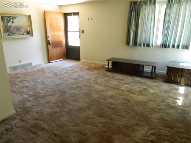 1928 Winston Road Colorado Springs, CO 80909 - Photo 2 of 16 Living room from dining area.