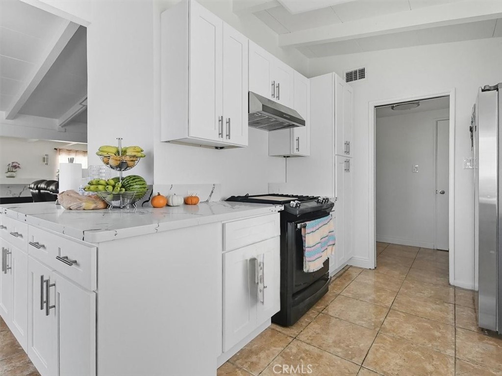 1407 Colonial Avenue Anaheim, CA 92802 - Photo 12 of 33 a kitchen with a white cabinets and white appliances