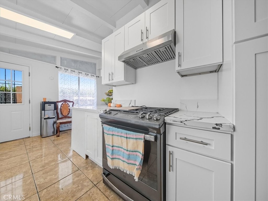 1407 Colonial Avenue Anaheim, CA 92802 - Photo 13 of 33 a kitchen with stainless steel appliances granite countertop a stove and a sink