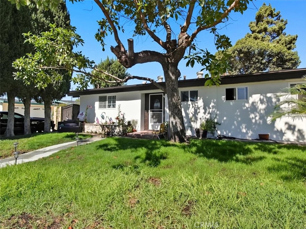 1407 Colonial Avenue Anaheim, CA 92802 - Photo 2 of 33 a view of a house with a yard and a tree