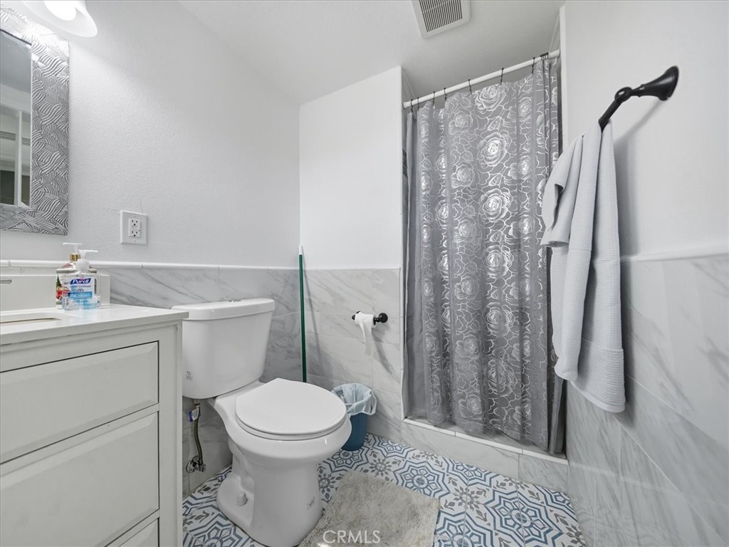 1407 Colonial Avenue Anaheim, CA 92802 - Photo 22 of 33 a bathroom with a toilet a sink and shower