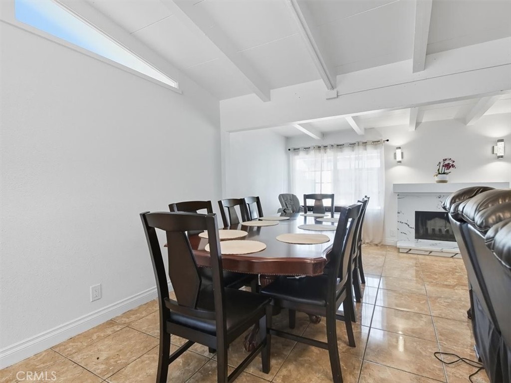 1407 Colonial Avenue Anaheim, CA 92802 - Photo 9 of 33 a view of a dining room and livingroom with furniture wooden floor a rug a painting and a chandelier