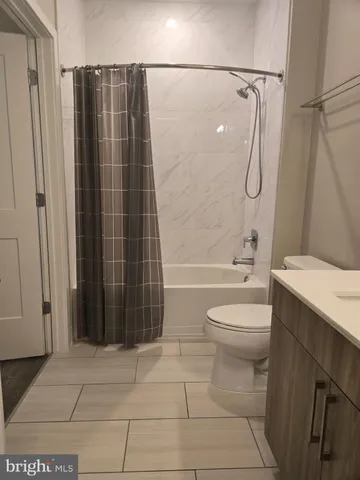 a bathroom with a toilet a sink and shower