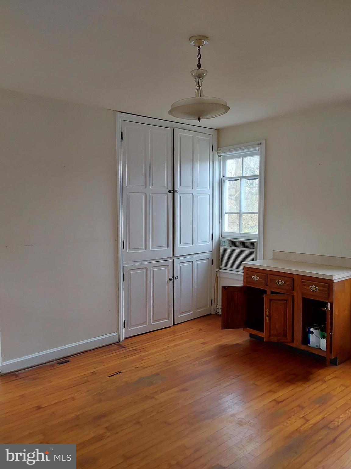 4300 Main Street Rohrersville, MD 21779 - Photo 5 of 19 a view of an empty room with wooden floor fireplace and a window