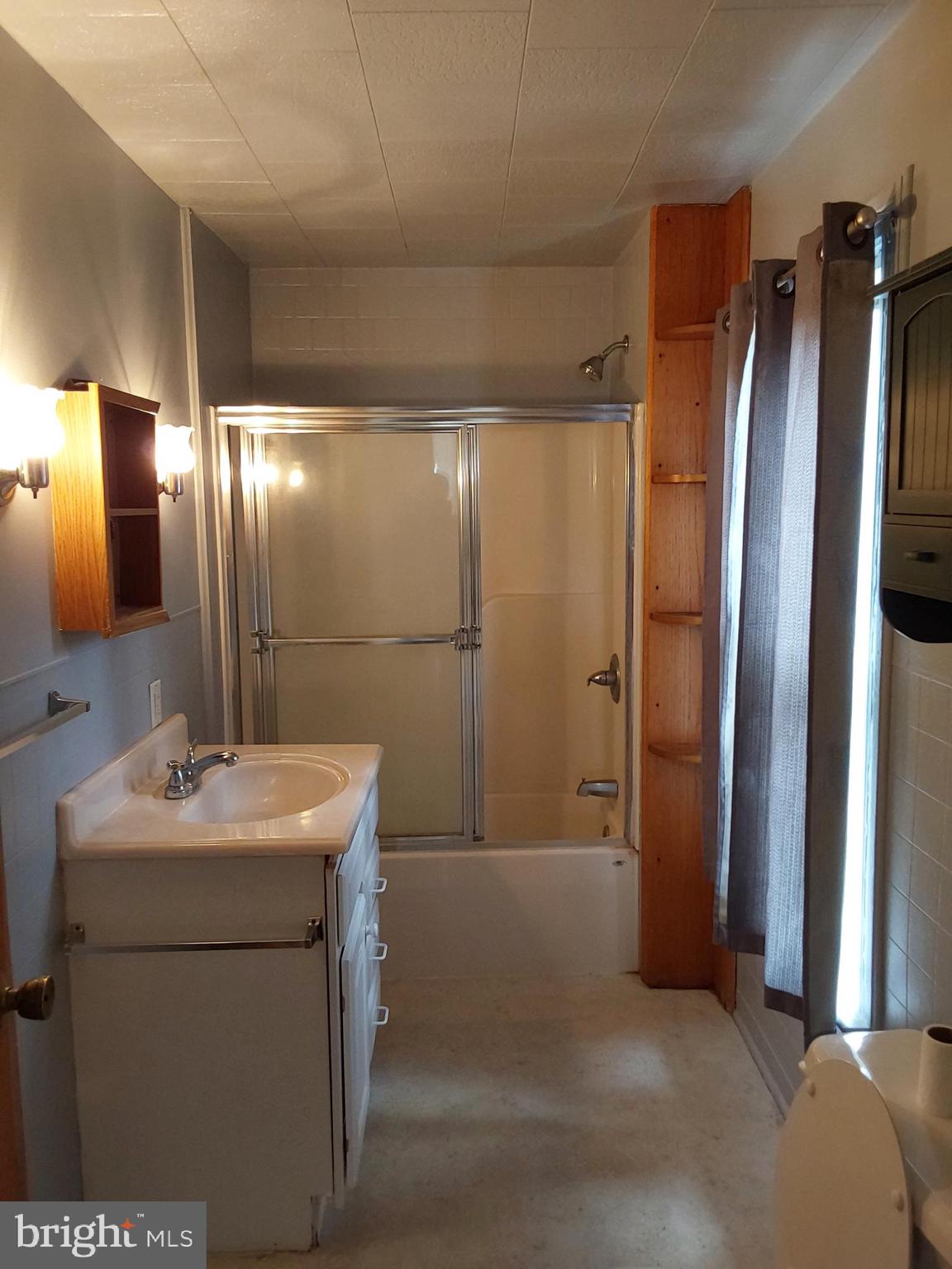 4300 Main Street Rohrersville, MD 21779 - Photo 9 of 19 a bathroom with a sink a toilet and mirror