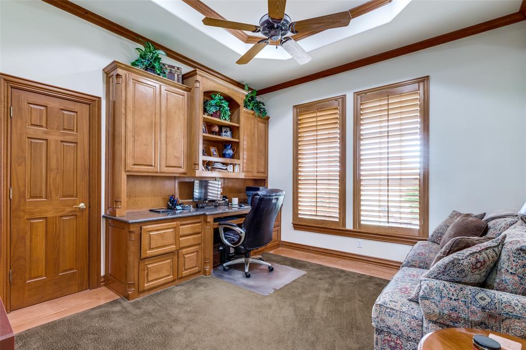 12198 Bell Road Pilot Point, TX 76258 - Photo 14 of 40 Office/study featuring ceiling fan, a raised ceiling, crown molding, built in desk & cabinets, & access to bathroom.