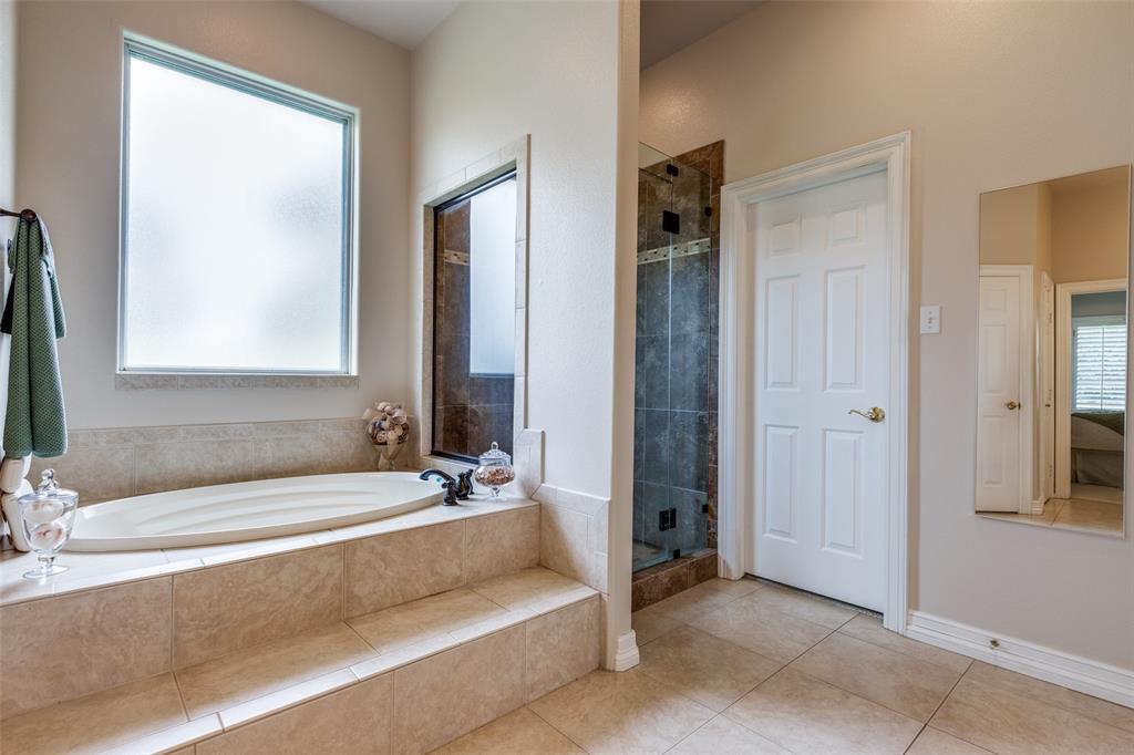 12198 Bell Road Pilot Point, TX 76258 - Photo 19 of 40 Primary ensuite bathroom featuring independent shower, bathtub, and tile floors