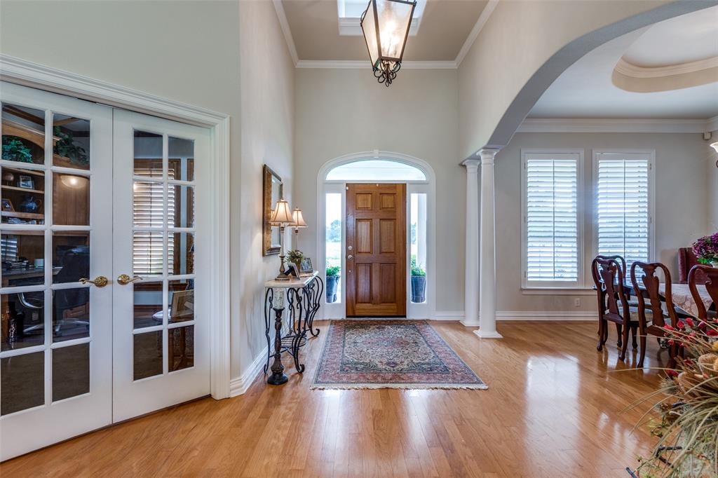12198 Bell Road Pilot Point, TX 76258 - Photo 2 of 40 Grand entrance foyer with wood floors, french doors, ornamental molding, and ornate columns