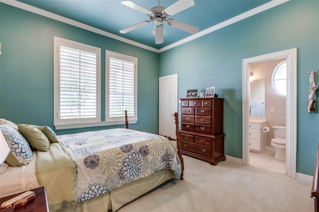 12198 Bell Road Pilot Point, TX 76258 - Photo 20 of 40 Carpeted secondary bedroom featuring ensuite full bathroom, ceiling fan, and crown molding