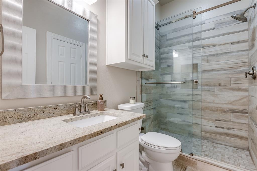 12198 Bell Road Pilot Point, TX 76258 - Photo 23 of 40 Secondary bathroom with walk-in custom tile shower, custom cabinets, and large granite vanity