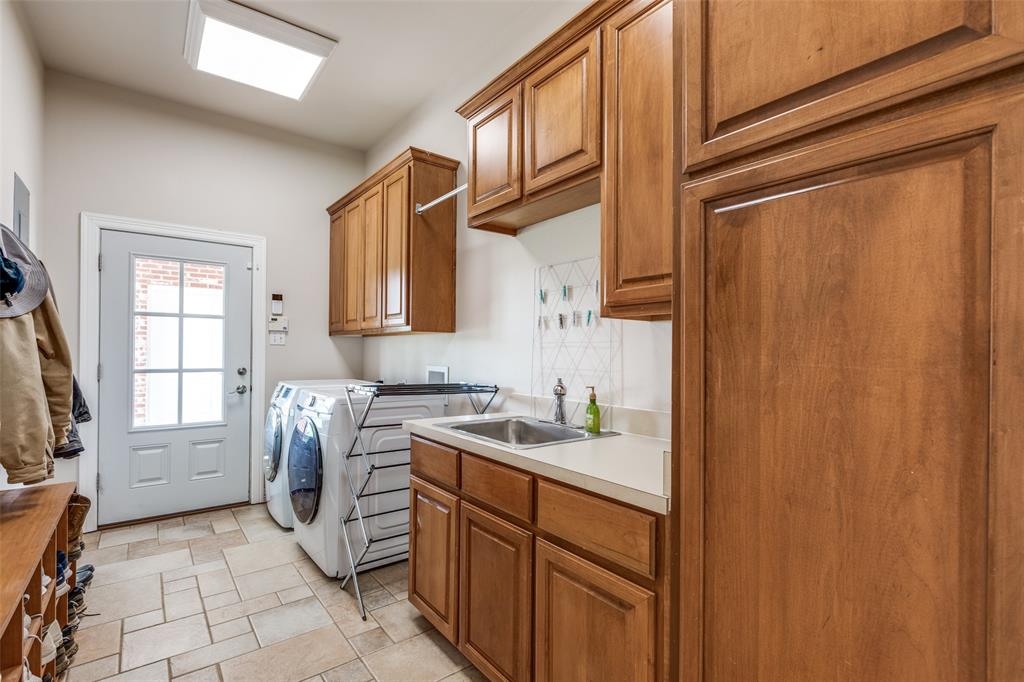 12198 Bell Road Pilot Point, TX 76258 - Photo 24 of 40 Clothes washing area featuring hookup for full-size washer and dryer, tile flooring, sink, and built-in cabinets
