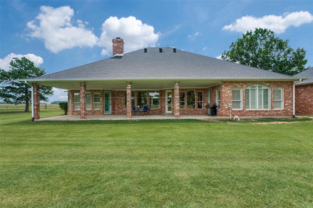12198 Bell Road Pilot Point, TX 76258 - Photo 27 of 40 Rear view of home featuring the patio area and large backyard