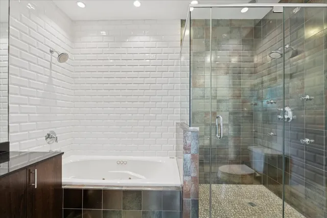 a bathroom with a bathtub and shower