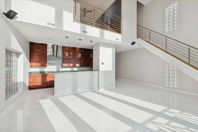 a view of large kitchen with stainless steel appliances cabinets