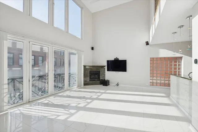 a view of a livingroom with wooden floor and flat screen tv
