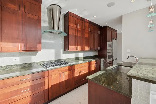 a kitchen with granite countertop a sink a counter space and cabinets