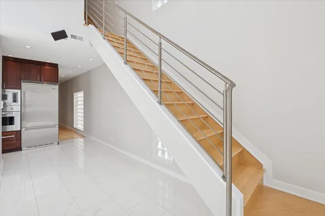 a view of staircase with white walls and a window