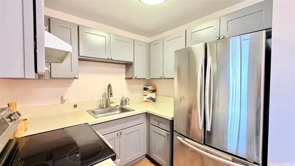 a kitchen with a refrigerator and a sink