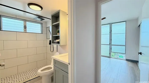 a bathroom with a toilet and a shower