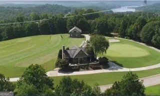 an aerial view of a house with yard swimming pool and outdoor seating