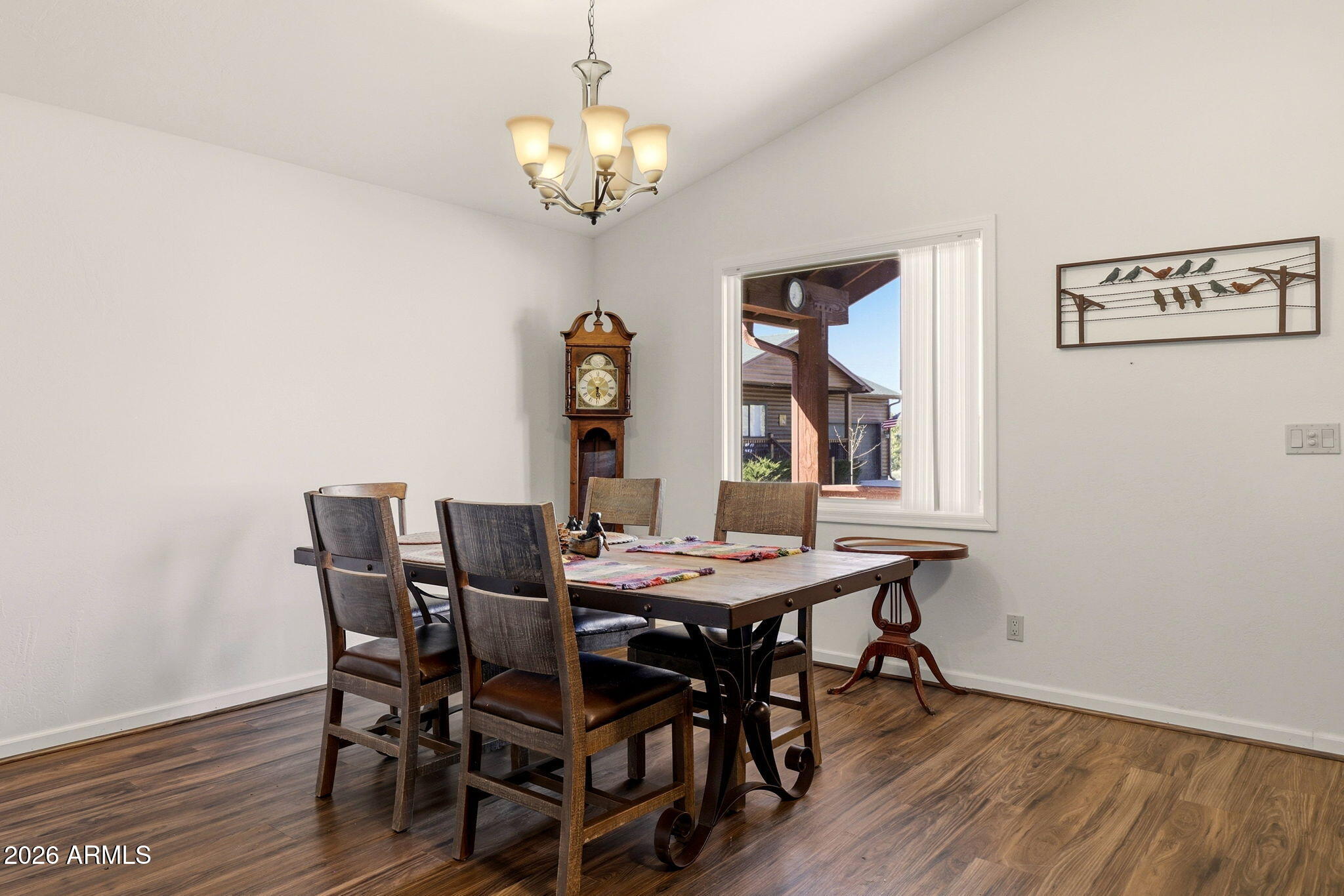 2746 Pineview Court Overgaard, AZ 85933 - Photo 11 of 30 a view of a dining room with furniture a chandelier and wooden floor