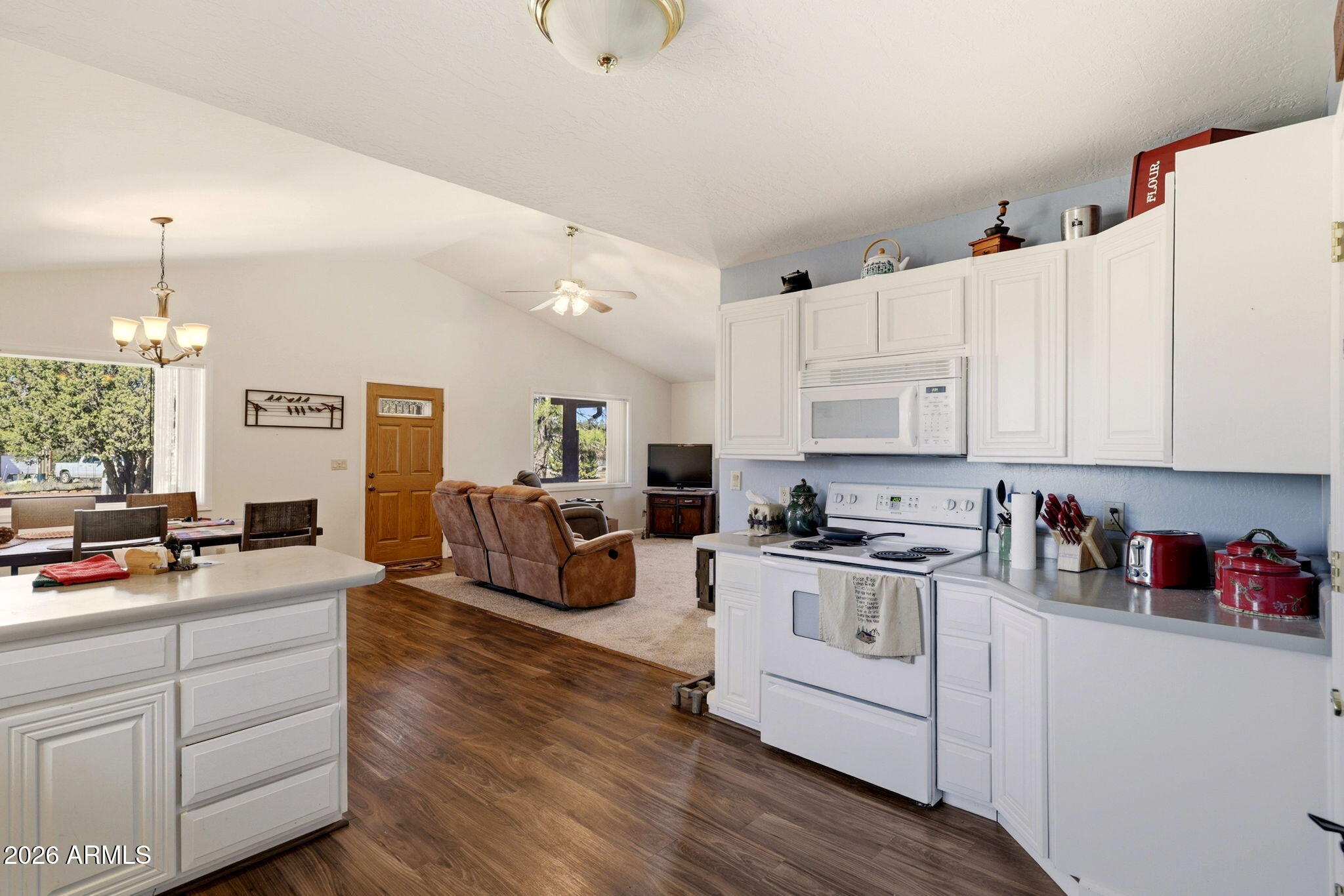 2746 Pineview Court Overgaard, AZ 85933 - Photo 13 of 30 a kitchen with white cabinets and white appliances