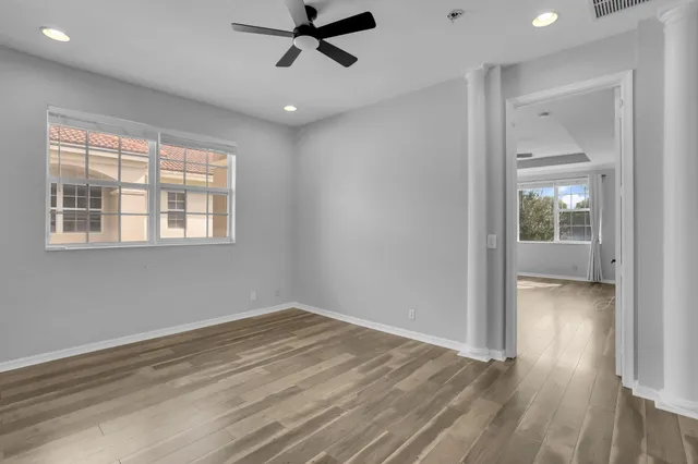 a view of a room with wooden floor and windows
