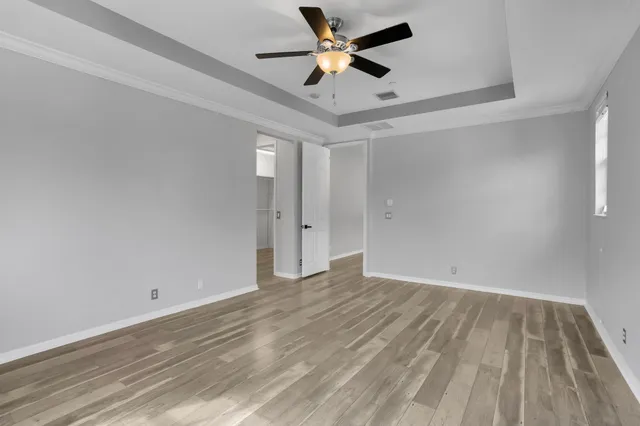 a view of empty room with wooden floor