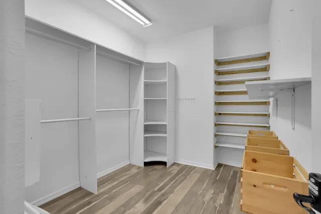 a view of walk in closet with empty racks