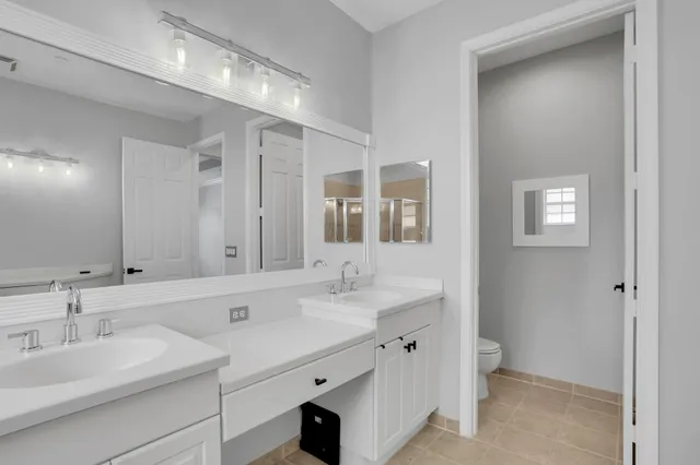 a bathroom with a sink double vanity and a mirror