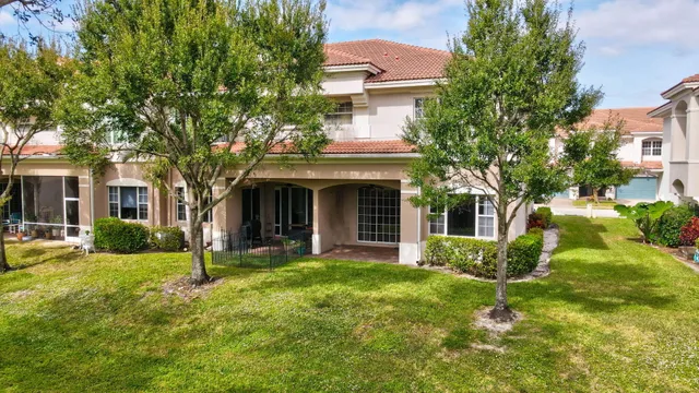 a front view of a house with a yard and trees