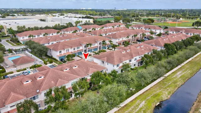 an aerial view of residential houses with outdoor space and river