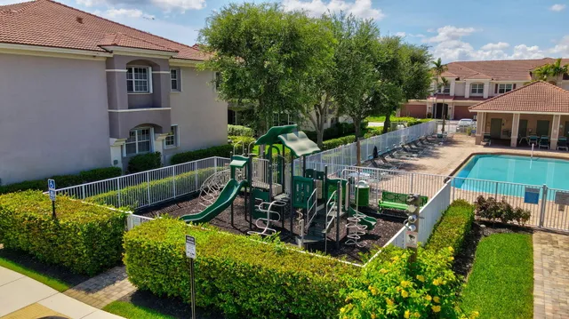 an aerial view of a house with swimming pool garden and patio