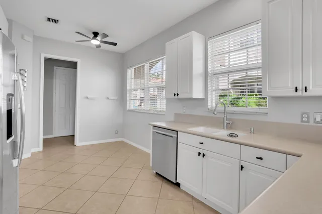 a kitchen with a sink cabinets and window