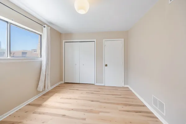a view of a room with wooden floor and closet