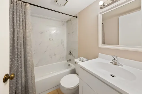 a bathroom with a sink toilet and shower