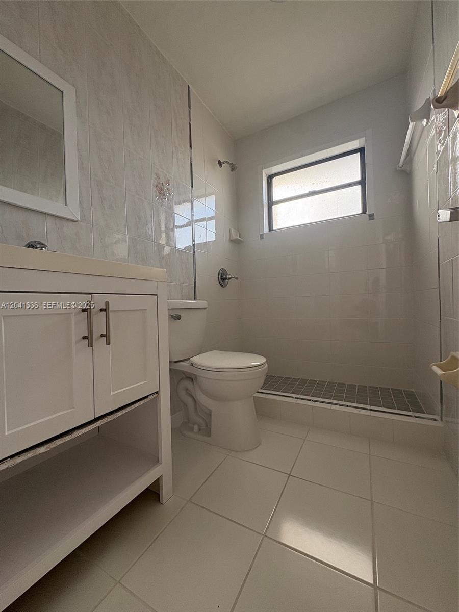 231 East 7th Street, Unit 202 Hialeah, FL 33010 - Photo 7 of 7 a bathroom with a toilet sink and vanity