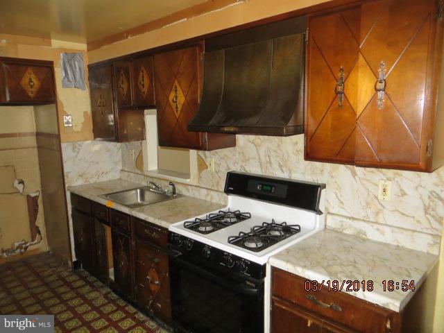 8149 Del Haven Road Baltimore, MD 21222 - Photo 3 of 18 a kitchen with a stove and a sink