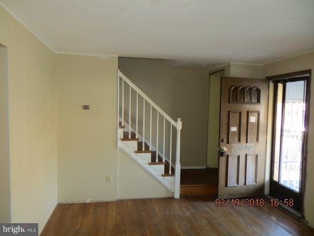 8149 Del Haven Road Baltimore, MD 21222 - Photo 7 of 18 a view of an entryway with wooden floor and door