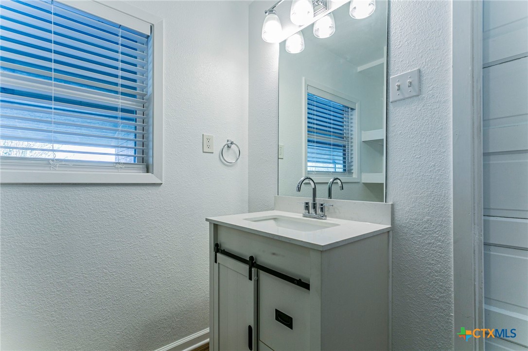 301 Thomas Street Rogers, TX 76569 - Photo 11 of 29 a bathroom with a sink and a mirror