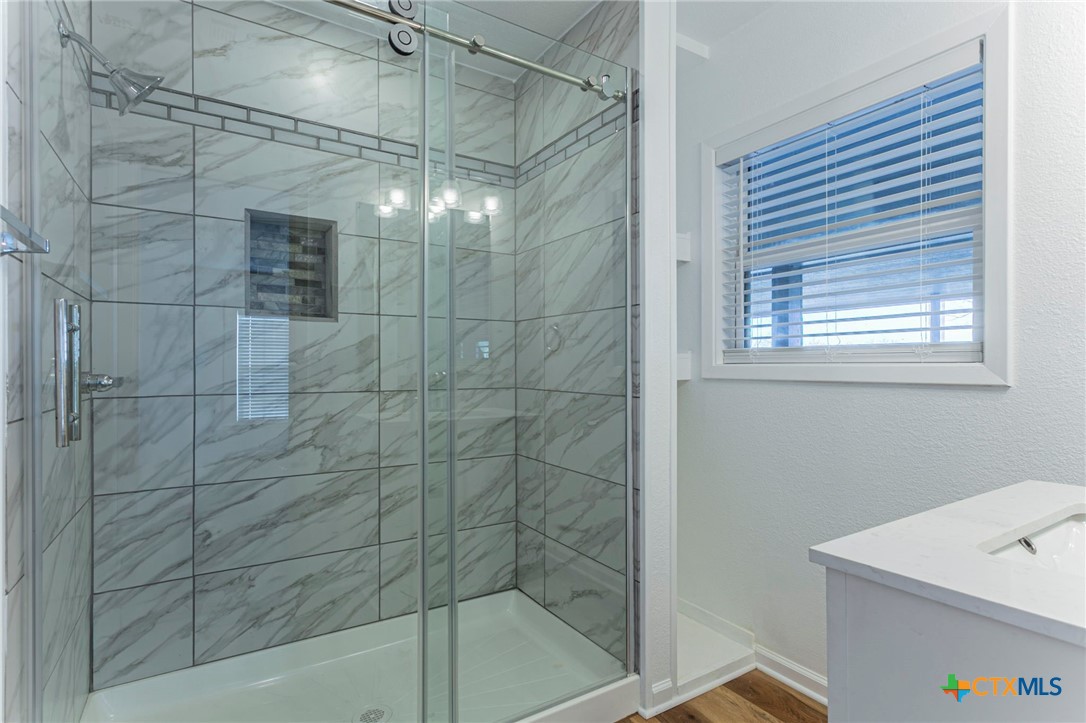 301 Thomas Street Rogers, TX 76569 - Photo 12 of 29 a bathroom with a shower and a sink