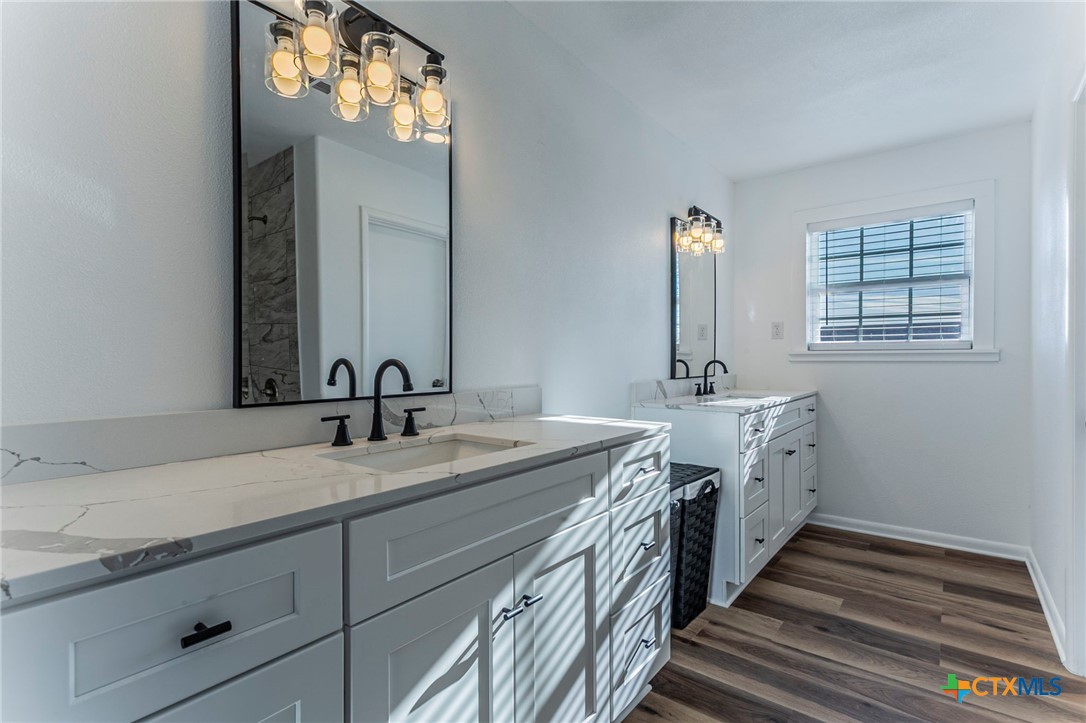 301 Thomas Street Rogers, TX 76569 - Photo 15 of 29 a bathroom with double vanity and a mirror