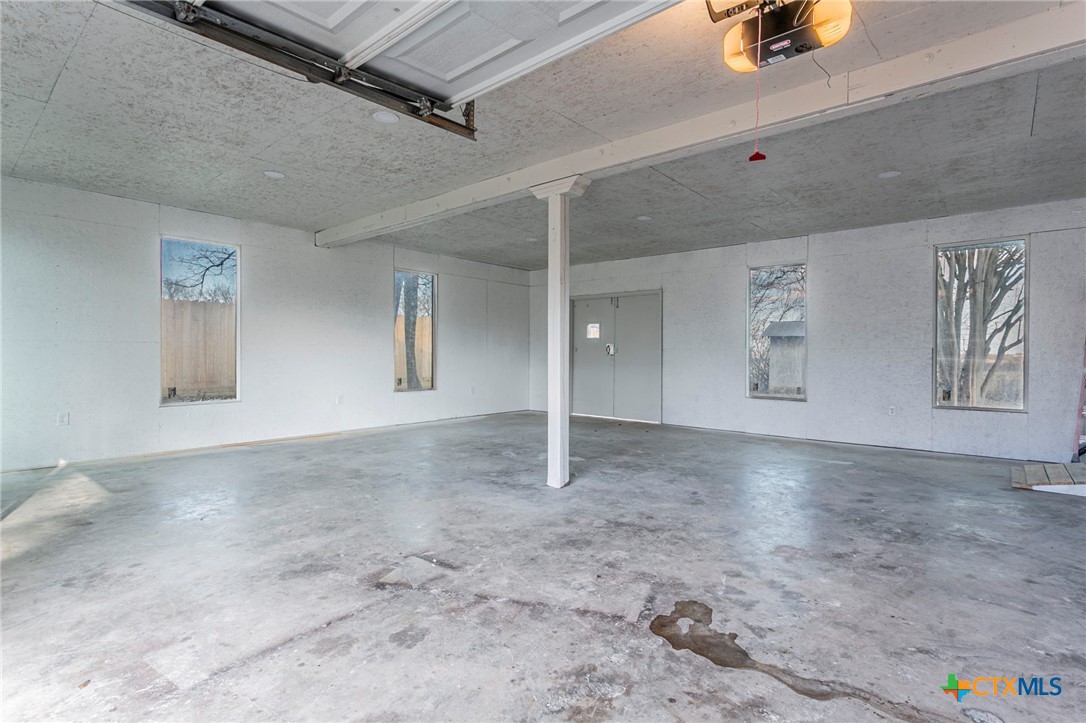 301 Thomas Street Rogers, TX 76569 - Photo 19 of 29 an empty room with windows