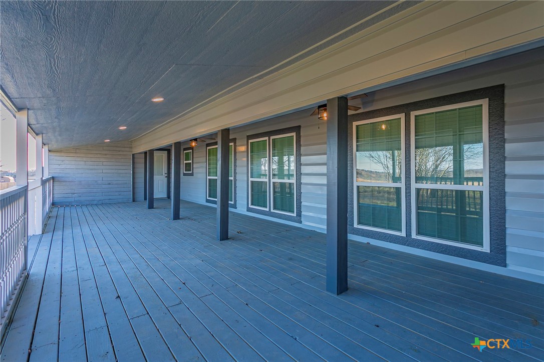 301 Thomas Street Rogers, TX 76569 - Photo 24 of 29 a view of empty room with wooden floor and windows